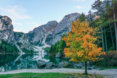 Scenic view of lake by mountain against sky