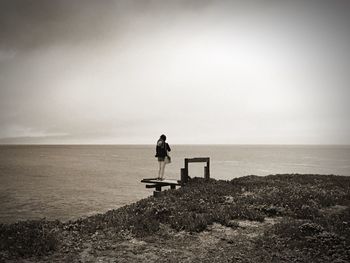 Rear view of man sitting on beach
