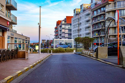 Street amidst buildings in city against sky