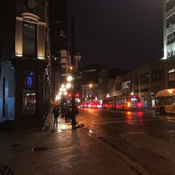 Illuminated city street at night