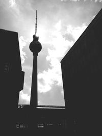 Low angle view of tower against cloudy sky