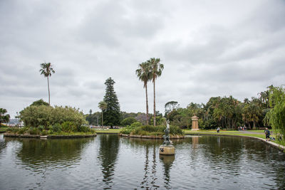 Scenic view of lake against cloudy sky at park