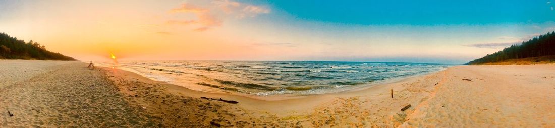 Panoramic view of beach against sky during sunset