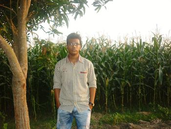 Portrait of young man standing on field