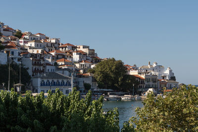 Buildings in city against clear sky