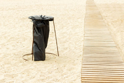 Homemade garbage container from a garbage bag on the beach