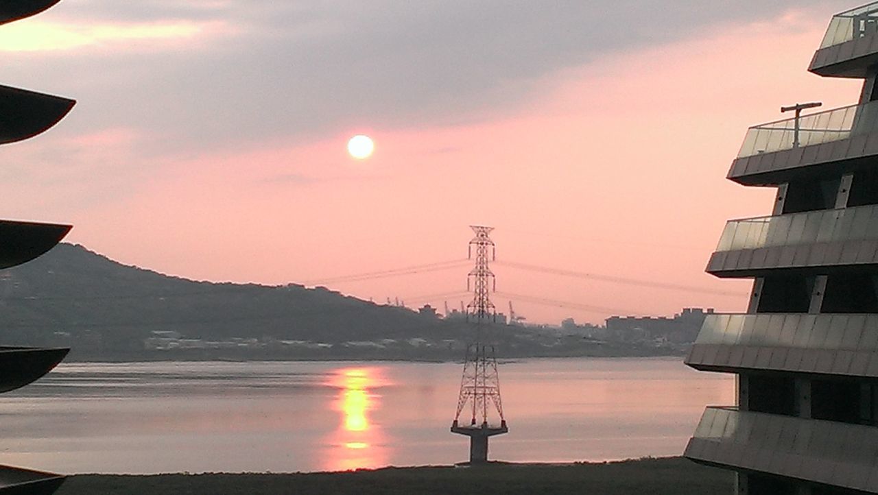 sunset, sky, scenics, water, tranquility, beauty in nature, tranquil scene, sun, mountain, nature, idyllic, reflection, cloud - sky, silhouette, outdoors, orange color, built structure, no people, mountain range, waterfront