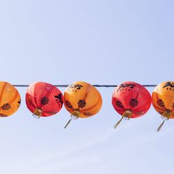 Low angle view of chinese lanterns against clear sky