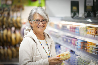 Portrait of smiling woman standing in store