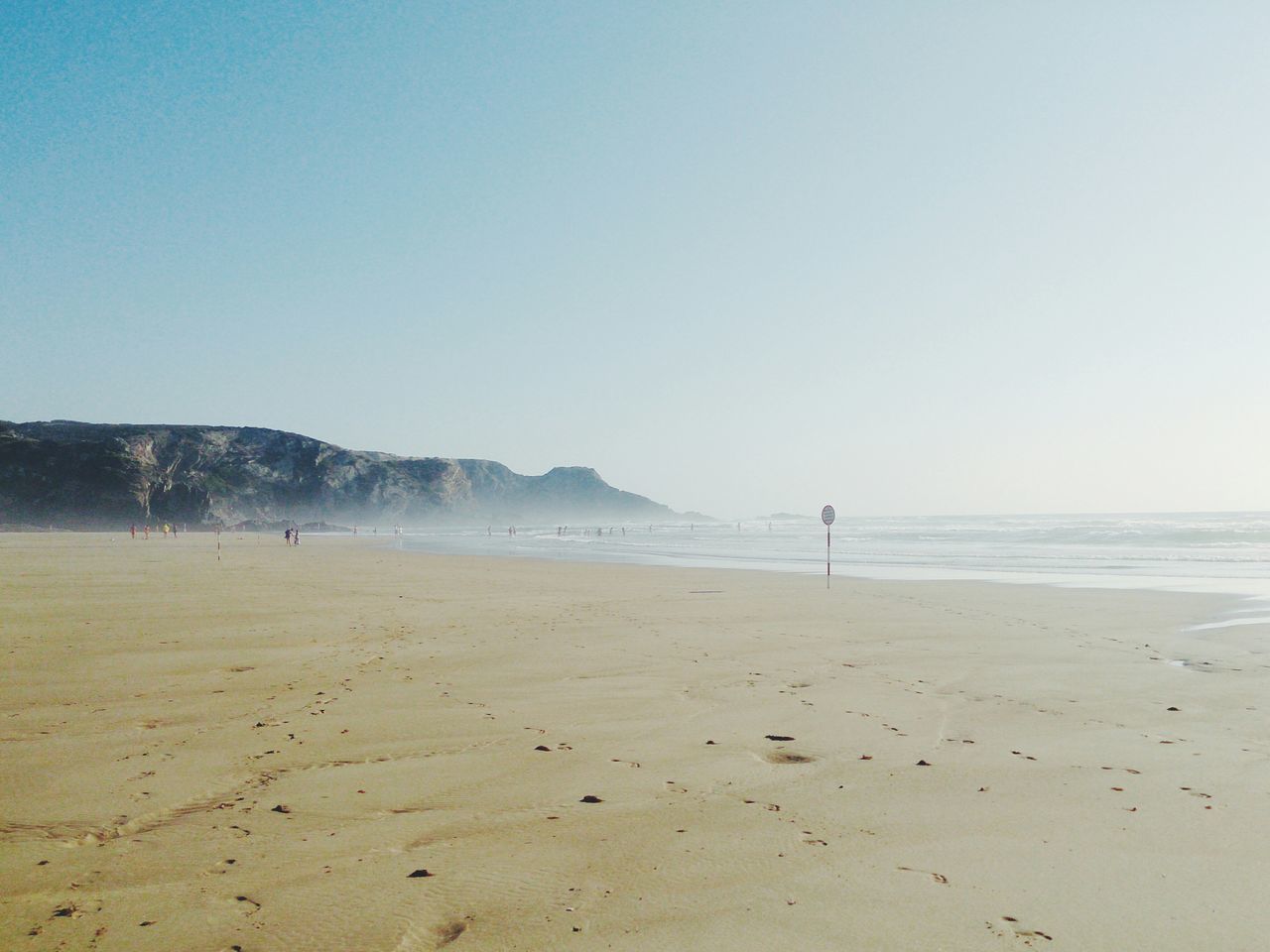 beach, sea, sand, shore, horizon over water, clear sky, water, tranquil scene, copy space, tranquility, scenics, beauty in nature, nature, coastline, wave, incidental people, idyllic, vacations, remote, blue