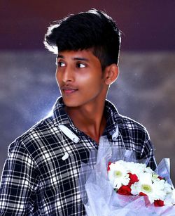 Young man holding flower bouquet