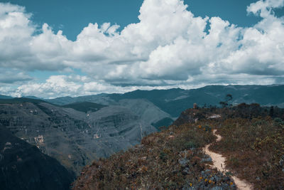 Scenic view of mountains against cloudy sky