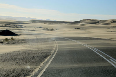 Scenic view of land road against sky