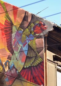 Low angle view of multi colored wall against sky