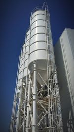 Low angle view of factory against clear sky