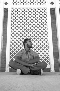 Portrait of young man sitting on floor