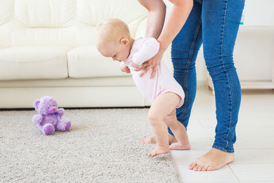 Mother playing with daughter at home