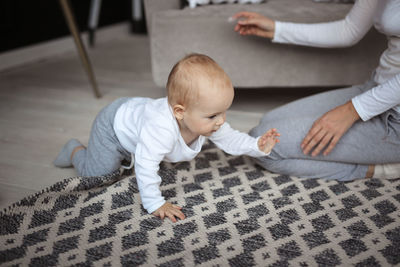 High angle view of cute boy sitting on floor