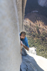 Climber lead climbing changing corners on the nose, yosemite, capitan