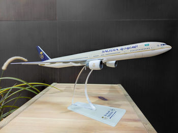 Close-up of airplane on table against wall