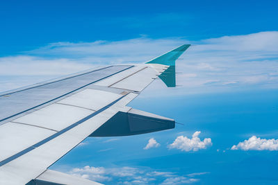 Cropped image of airplane wing against sky
