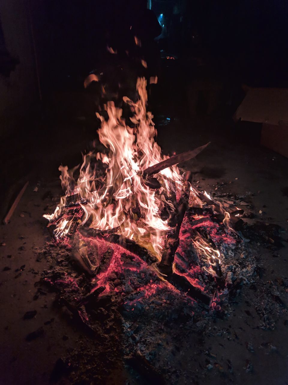 HIGH ANGLE VIEW OF BURNING FIRE IN DARK