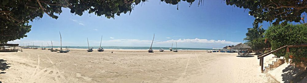 Scenic view of beach against blue sky