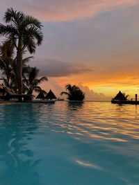 Scenic view of swimming pool against sky during sunset