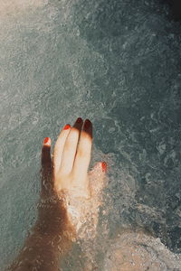 Low section of person with reflection in water