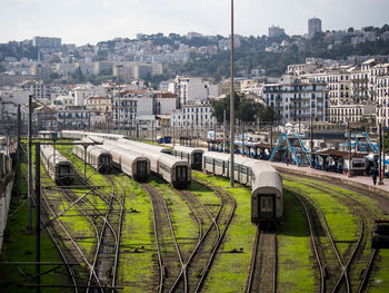 High angle view of train on railroad tracks amidst buildings in city