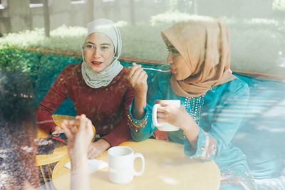 Young woman holding coffee cup