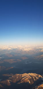 Aerial view of landscape against blue sky