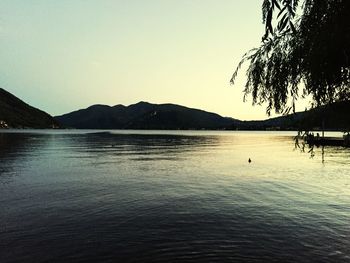 Scenic view of lake against clear sky during sunset