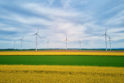 Wind generators over colorful agricultural fields. green energy development