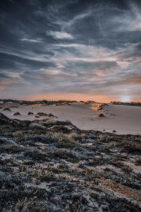 Scenic view of land against sky during sunset