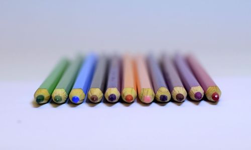 Close-up of colorful colored pencils over white background