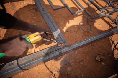 Low section of person working on wood