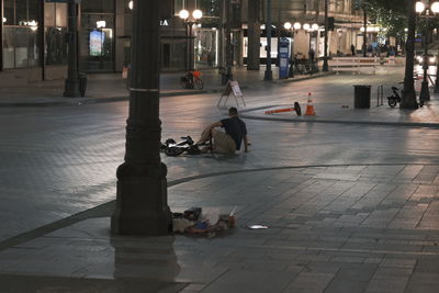 People on sidewalk in city at night