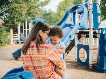 Mother and son embracing in park
