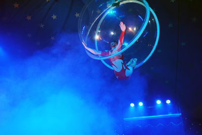 Low angle view of bubbles in mid-air at night