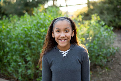 Young teen girl smiles for a portrait outside