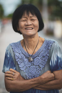 Smiling woman with arms crossed