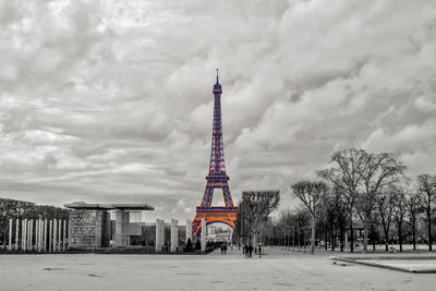 Tower and buildings in city against sky