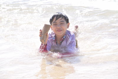 Portrait of smiling boy in water