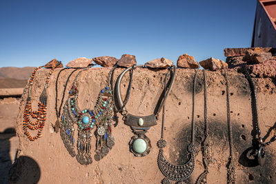 Variety of jewelry necklaces on wall for sale at local market