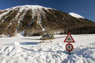 Raer view of a private jet airplane and a signage in aiport of st moritz switzerland