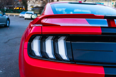 Close-up of red car on street