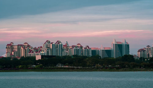 Scenic view of buildings against sky during sunset