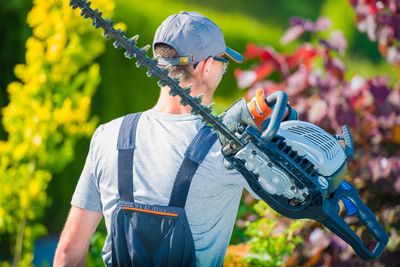 Man carrying hedge trimmer