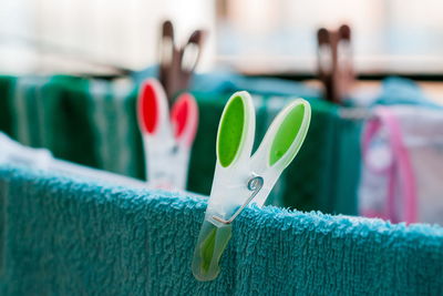 Close-up of multi colored clothespins on clothesline